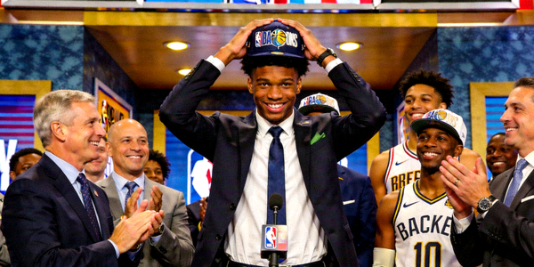 NBA选秀大会现场，新秀戴上球队帽子